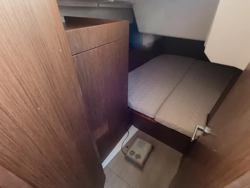 Slide: The Image of Cabin interior of 2021 Beneteau Oceanis 38.1 yacht with wooden finish and cozy bed. - 25