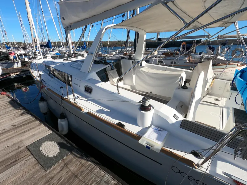 Slide: The Image of 2021 Beneteau Oceanis 38.1 sailboat docked at marina under clear blue sky. - 4