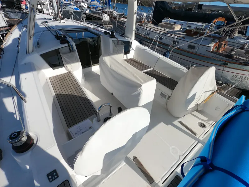 Slide: The Image of 2021 Beneteau Oceanis 38.1 yacht cockpit with seating and marina view. - 6