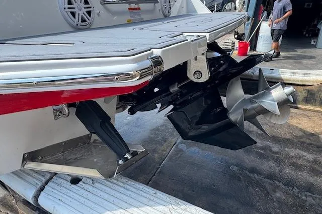 Slide: The Image of 2026 Cobalt CS23 boat stern with propeller and swim platform in a marina setting. - 10