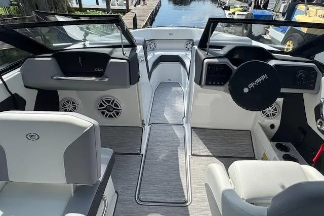 Slide: The Image of Interior of a 2026 Cobalt CS23 boat, featuring modern seating and dashboard design. - 13