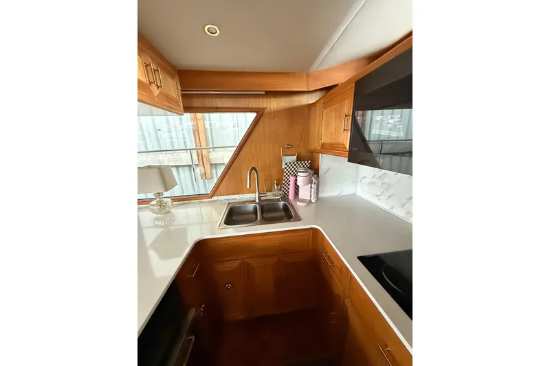 Slide: The Image of Luxurious kitchen interior of 1995 Ocean Alexander 486 yacht with wooden cabinetry and modern fixtures. - 19