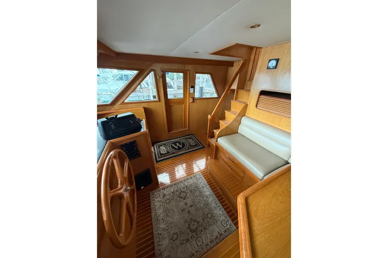 Slide: The Image of Interior of 1995 Ocean Alexander 486 yacht with wooden finish and seating area. - 25