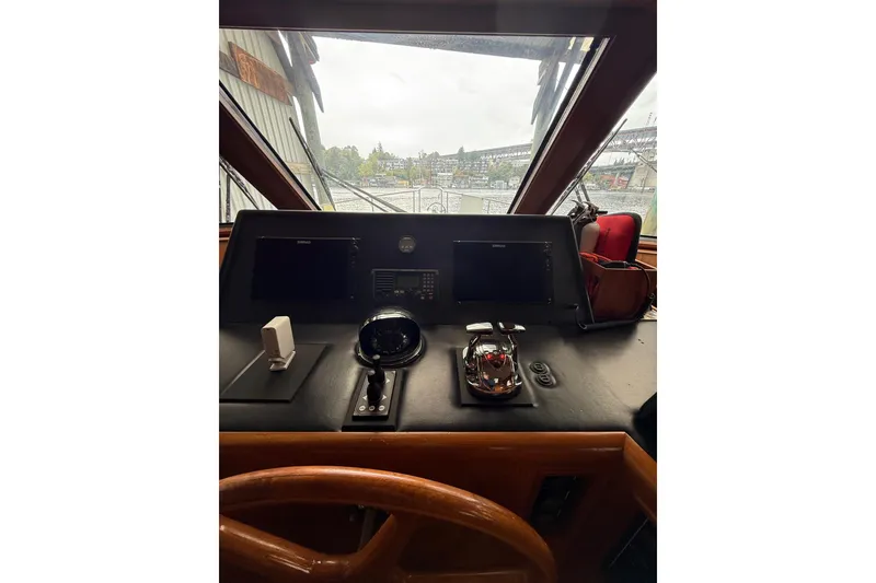 Slide: The Image of 1995 Ocean Alexander 486 yacht helm with navigation equipment and steering wheel. - 26