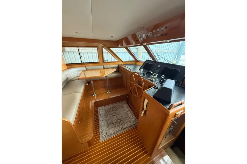 Slide: The Image of Luxurious 1995 Ocean Alexander 486 yacht interior with wood finish and helm station. - 27