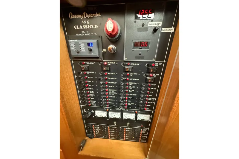 Slide: The Image of 1995 Ocean Alexander 486 Classico control panel with various switches and digital displays. - 28
