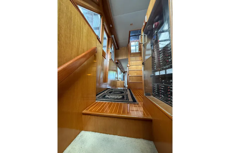 Slide: The Image of Interior of 1995 Ocean Alexander 486 yacht with wooden stairs and elegant design. - 29