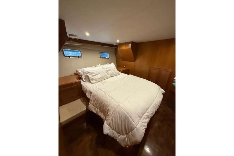 Slide: The Image of Luxurious bedroom interior of 1995 Ocean Alexander 486 yacht with cozy bedding. - 30