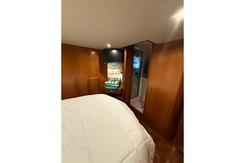 Slide: The Image of Cozy bedroom in 1995 Ocean Alexander 486 yacht with wood paneling and modern amenities. - 31