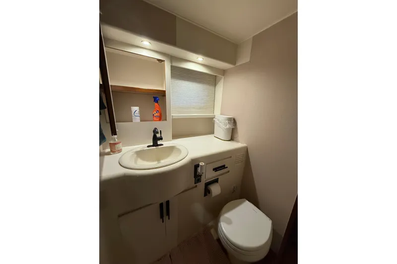 Slide: The Image of Bathroom interior of 1995 Ocean Alexander 486 yacht, featuring sink and toilet. - 32