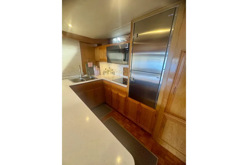 Slide: The Image of 1995 Ocean Alexander 486 yacht kitchen with stainless steel appliances and wooden cabinetry. - 39