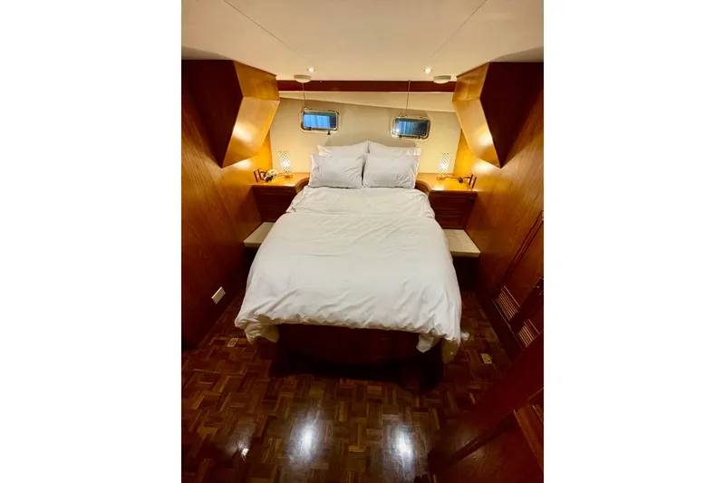 Slide: The Image of Cozy bedroom in 1995 Ocean Alexander 486 yacht with wood paneling and ambient lighting. - 43