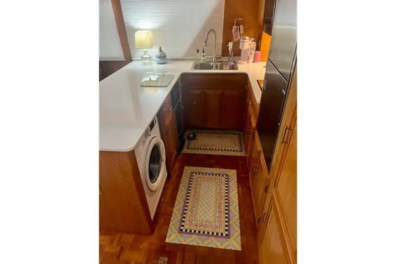 Slide: The Image of Interior of 1995 Ocean Alexander 486 yacht kitchen with wooden cabinets and modern appliances. - 44
