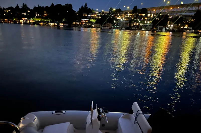Slide: The Image of Ocean Alexander 486 yacht on serene water with city lights reflecting, 1995 model. - 47