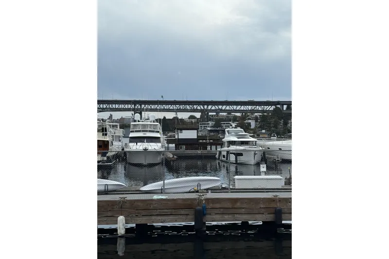 Slide: The Image of Marina with Ocean Alexander 486 yacht, 1995 model, docked under cloudy skies. - 49