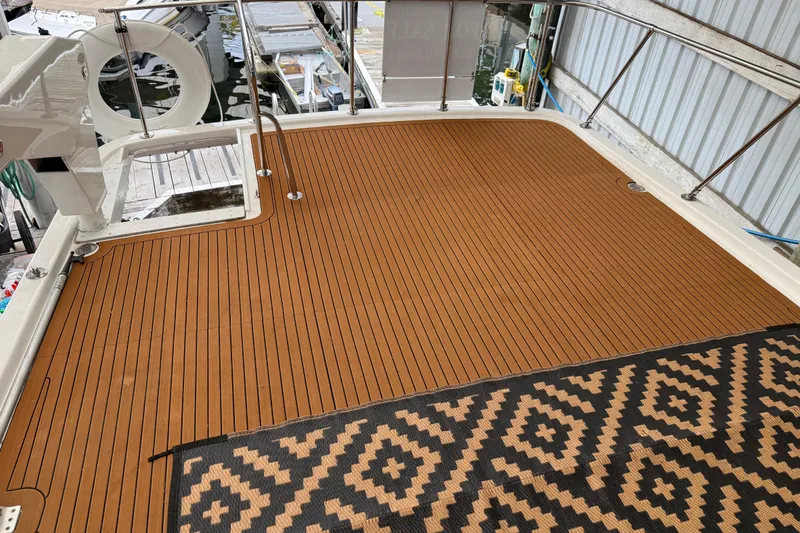 Slide: The Image of 1995 Ocean Alexander 486 yacht deck with patterned rug and railing. - 50