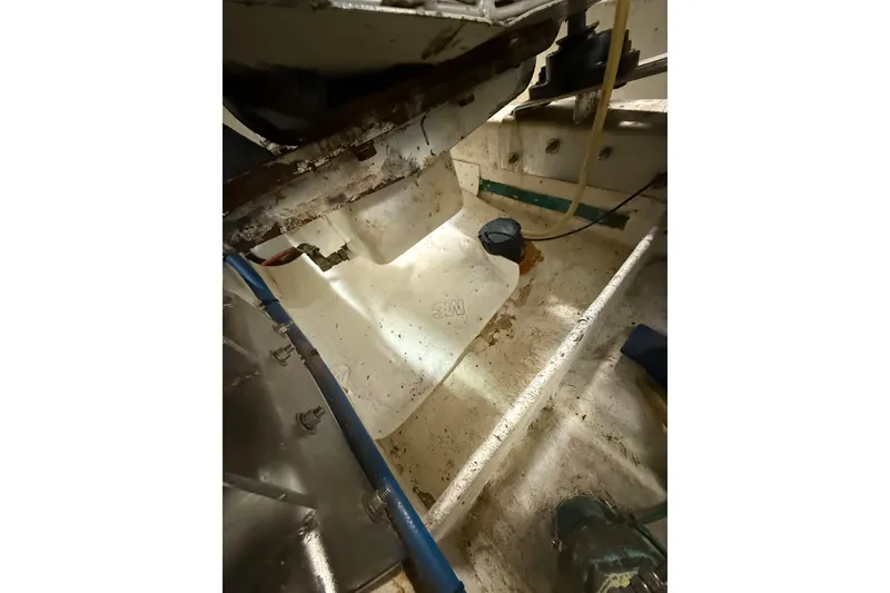 Slide: The Image of Engine room of 1995 Ocean Alexander 486 yacht, showing mechanical components and piping. - 53