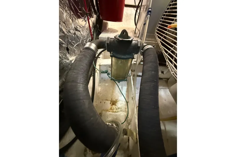 Slide: The Image of Engine compartment of 1995 Ocean Alexander 486 yacht, featuring hoses and filter system. - 55