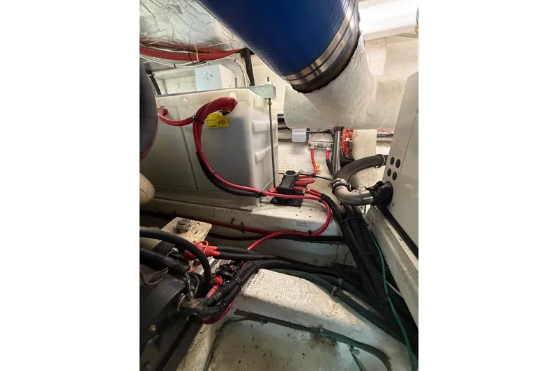 Slide: The Image of Engine room of 1995 Ocean Alexander 486 yacht with visible wiring and components. - 56