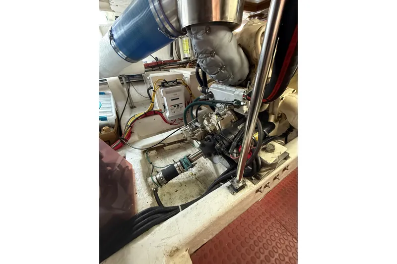 Slide: The Image of Engine room of 1995 Ocean Alexander 486 yacht, showcasing mechanical components and wiring. - 61