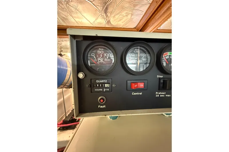 Slide: The Image of Control panel of a 1995 Ocean Alexander 486 yacht, featuring gauges and switches. - 63