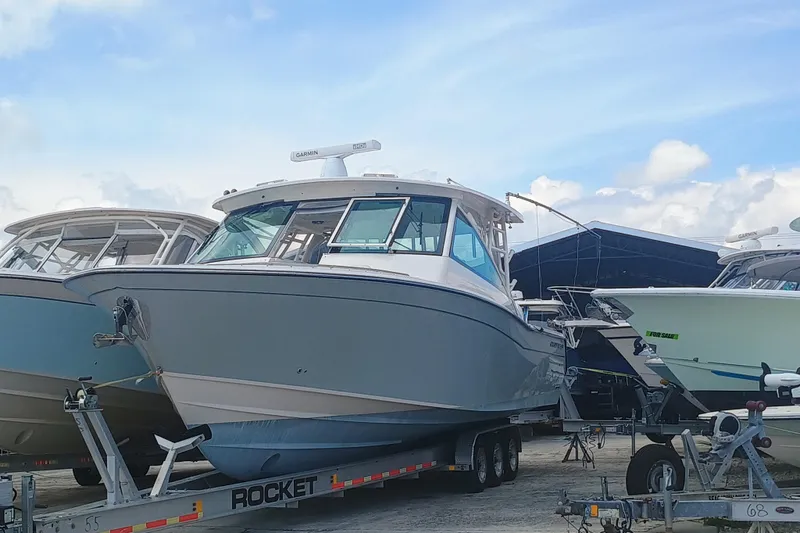 The Image of 2021 Grady-White Freedom 375 boat on trailer under blue sky. - 1