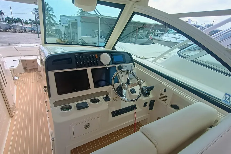 Slide: The Image of 2021 Grady-White Freedom 375 boat cockpit with modern controls and steering wheel. - 11