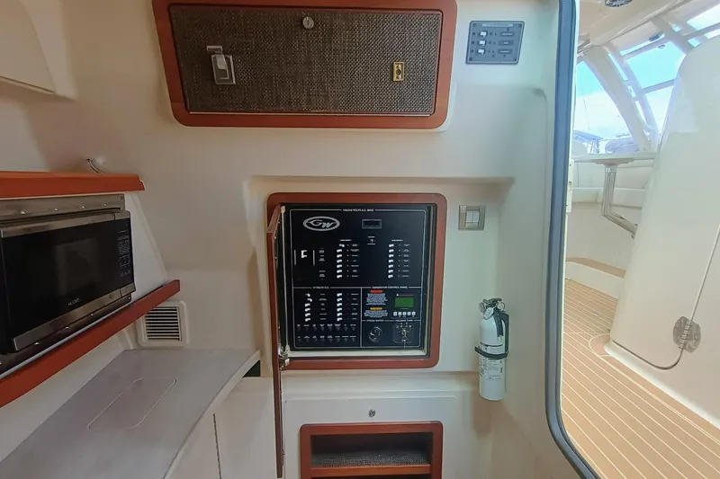Slide: The Image of 2021 Grady-White Freedom 375 interior with control panel, microwave, and fire extinguisher. - 17