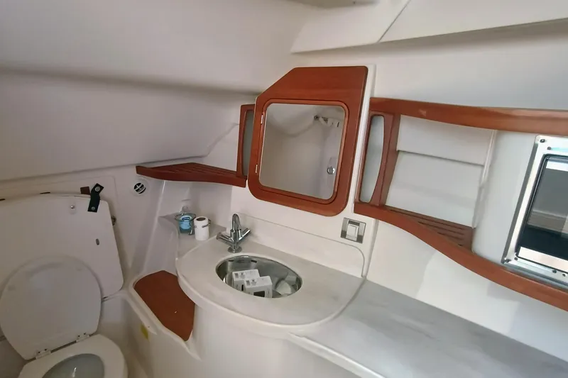 Slide: The Image of 2021 Grady-White Freedom 375 boat bathroom with sink, mirror, and wooden accents. - 19