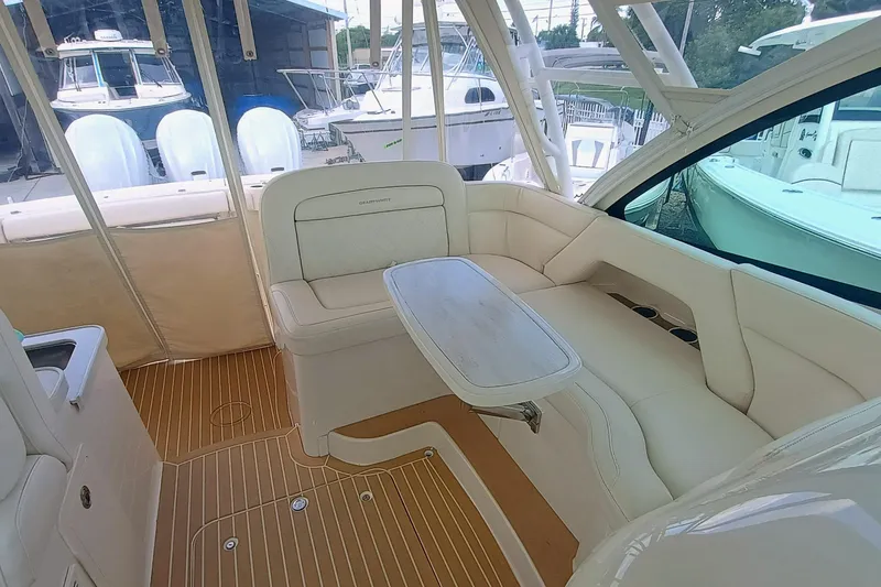 Slide: The Image of 2021 Grady-White Freedom 375 boat interior with white seating and wooden flooring. - 24