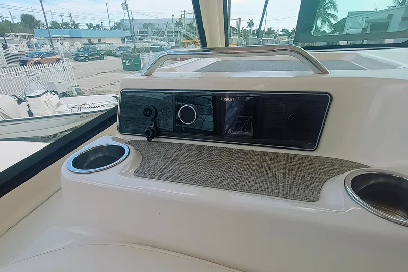 Slide: The Image of 2021 Grady-White Freedom 375 boat dashboard with Fusion audio system and cup holders. - 29