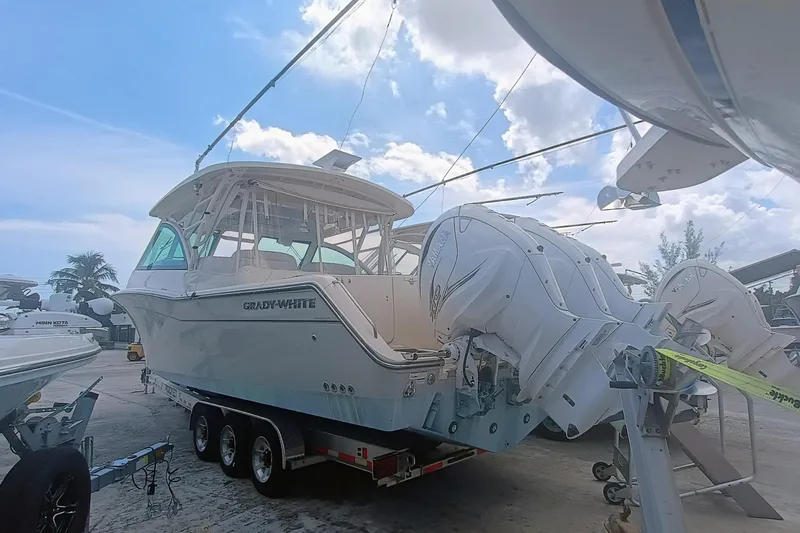 Slide: The Image of 2021 Grady-White Freedom 375 boat on trailer, featuring powerful outboard engines. - 3