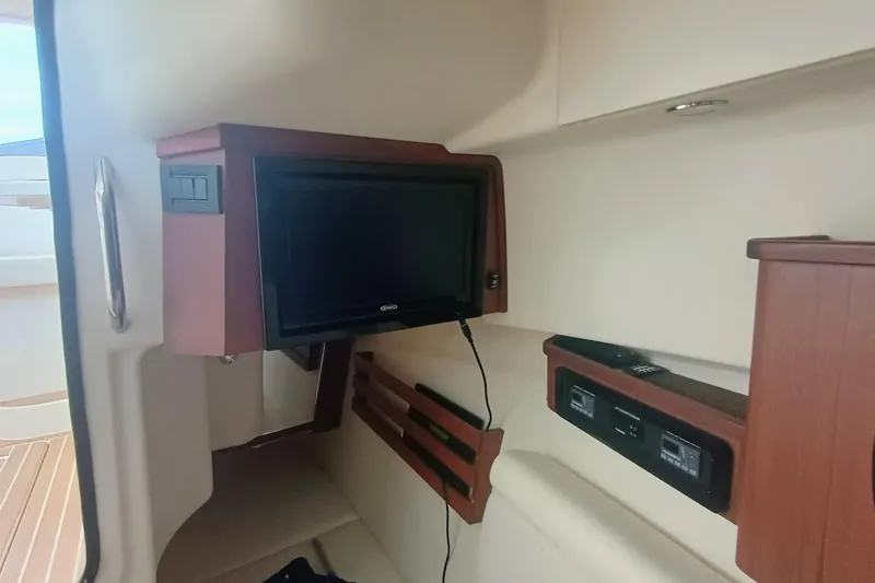Slide: The Image of Interior of 2021 Grady-White Freedom 375 boat with mounted TV and control panel. - 32