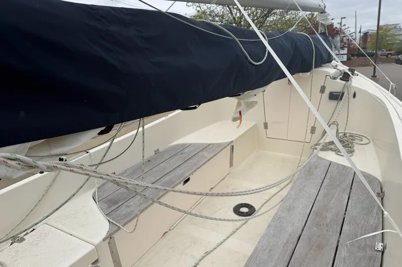 Slide: The Image of 2014 Com-Pac Horizon Day Cat sailboat interior with wooden benches and rigging. - 11