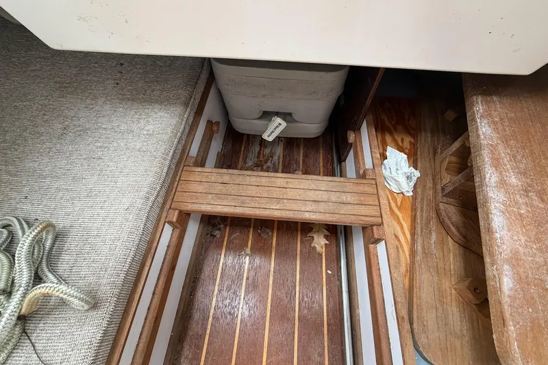 Slide: The Image of Interior of 2014 Com-Pac Horizon Day Cat showing wooden flooring and storage area. - 12