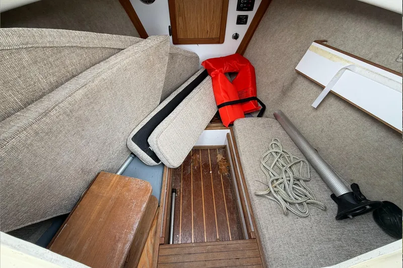 Slide: The Image of Interior of 2014 Com-Pac Horizon Day Cat with cushions, life jacket, and rope. - 13