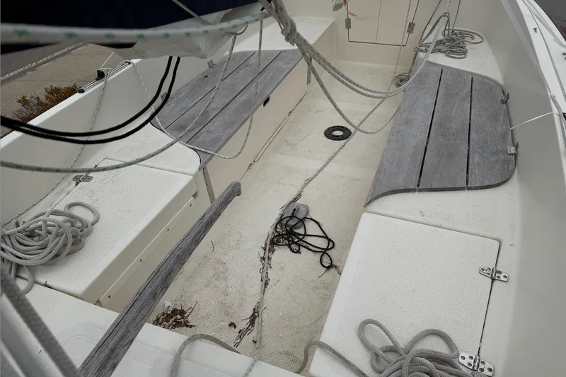 Slide: The Image of 2014 Com-Pac Horizon Day Cat sailboat interior with ropes and wooden seating. - 6