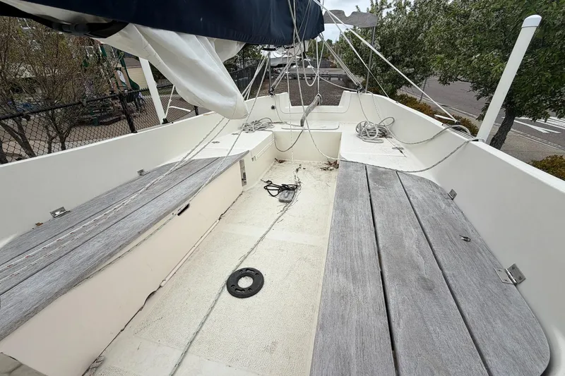Slide: The Image of 2014 Com-Pac Horizon Day Cat sailboat interior with wooden benches and rigging. - 7