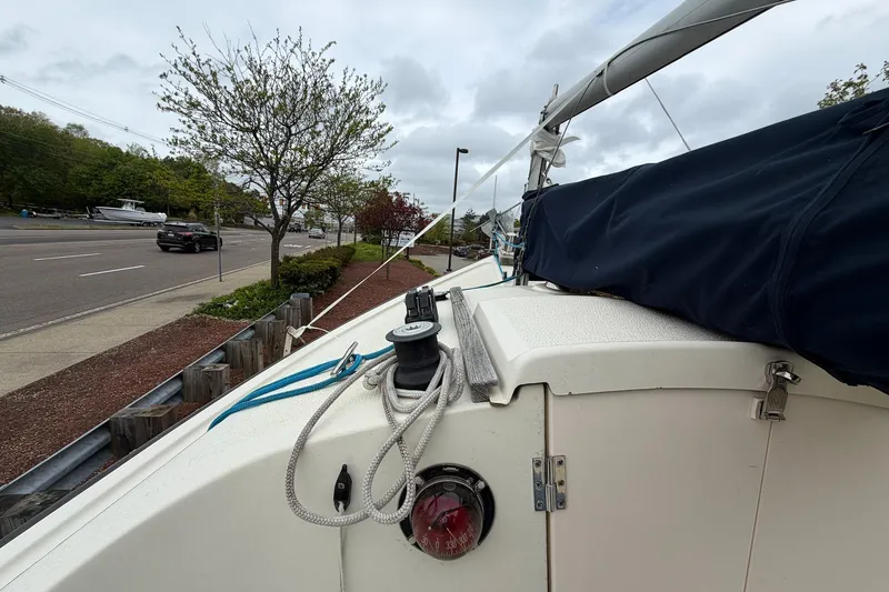 Slide: The Image of 2014 Com-Pac Horizon Day Cat sailboat docked near a road, overcast sky. - 9
