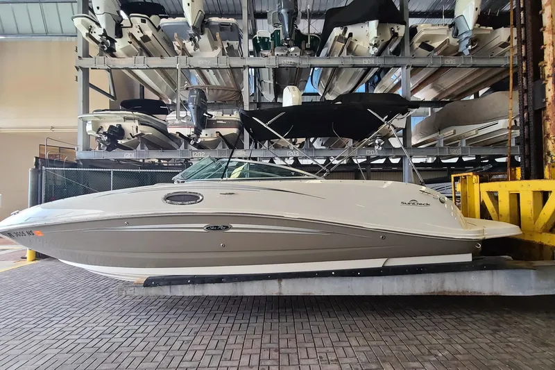 The Image of 2008 Sea Ray 260 Sundeck boat stored in a marina rack, side view. - 0