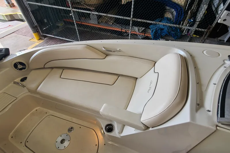 Slide: The Image of 2008 Sea Ray 260 Sundeck interior seating with beige upholstery and speaker detail. - 10