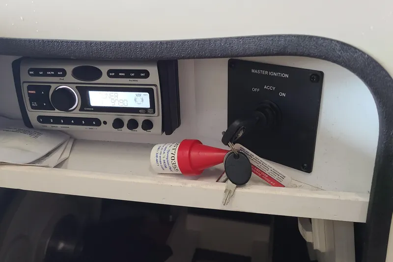 Slide: The Image of 2008 Sea Ray 260 Sundeck dashboard with stereo and ignition keys. - 16