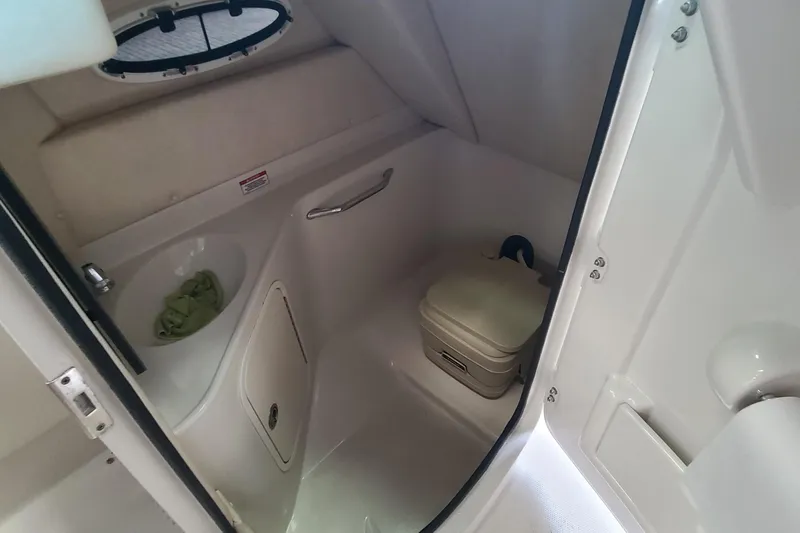 Slide: The Image of 2008 Sea Ray 260 Sundeck interior bathroom with sink and portable toilet. - 18
