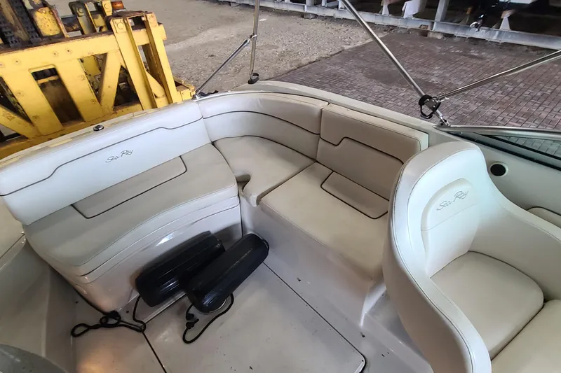 Slide: The Image of 2008 Sea Ray 260 Sundeck interior with beige seating and boat accessories. - 21
