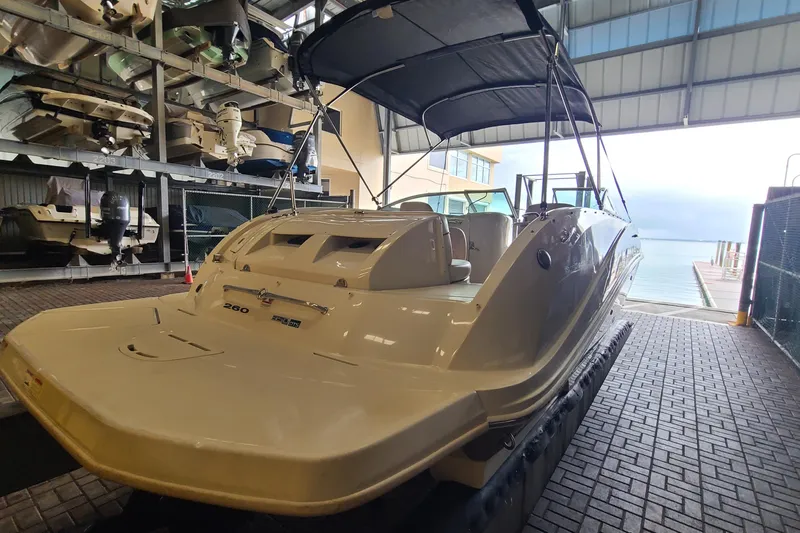 Slide: The Image of 2008 Sea Ray 260 Sundeck boat in indoor storage near waterfront. - 3