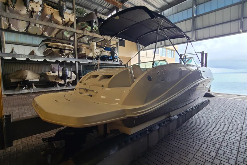 Slide: The Image of 2008 Sea Ray 260 Sundeck boat in storage, featuring a sleek design and canopy. - 4