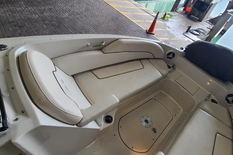 Slide: The Image of 2008 Sea Ray 260 Sundeck interior with beige seating and storage compartments. - 9