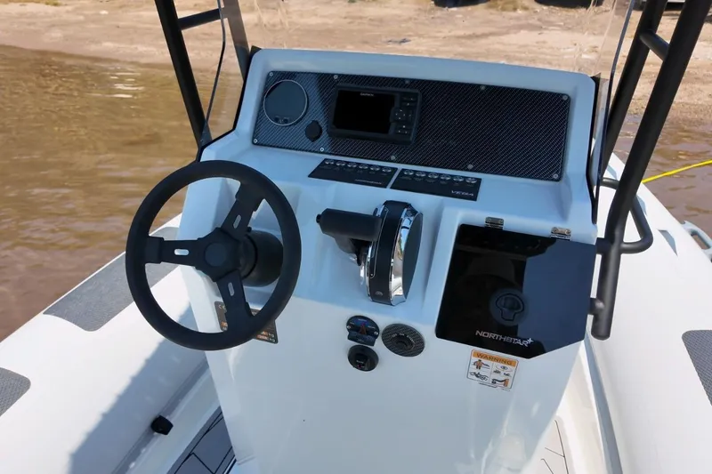 Slide: The Image of 2026 Northstar VEGA 5.4 boat console with steering wheel and control panel. - 10