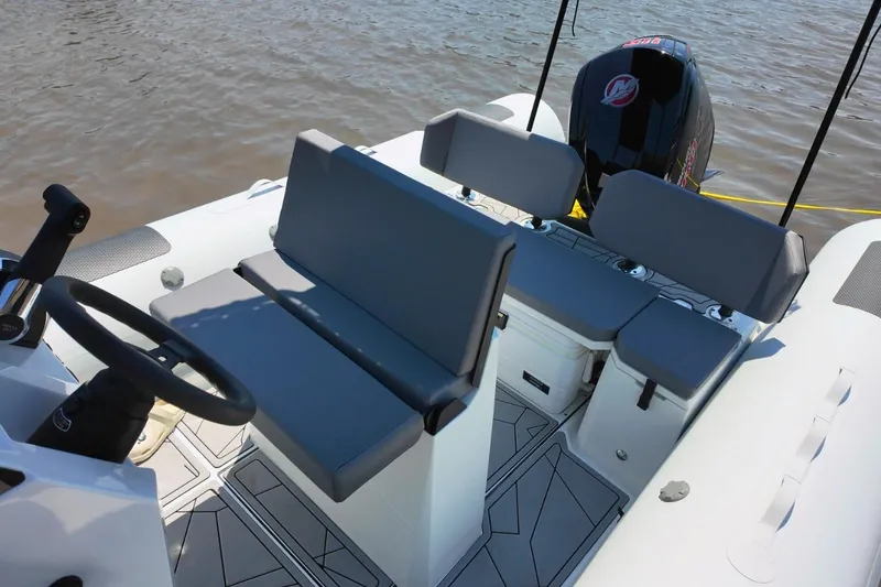 Slide: The Image of 2026 Northstar VEGA 5.4 boat interior with seating and steering wheel on water. - 11