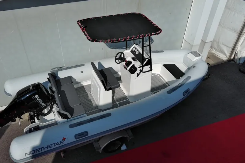 Slide: The Image of 2026 Northstar VEGA 5.4 boat with Suzuki engine, overhead view. - 3